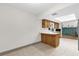 Open kitchen area with light wood cabinets and a breakfast bar at 2098 Heathwood St, Deltona, FL 32725