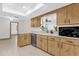 Bright kitchen featuring light wood cabinets, tile flooring, and modern appliances at 2098 Heathwood St, Deltona, FL 32725