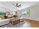 Bright and inviting living room featuring a large window, modern fan, and stylish décor at 2098 Heathwood St, Deltona, FL 32725