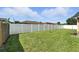 Spacious backyard featuring a well-maintained lawn and a tall privacy fence at 22 Bradford Ct, Kissimmee, FL 34758
