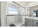 Clean bathroom featuring glass shower, marble countertops and gray cabinetry at 22 Bradford Ct, Kissimmee, FL 34758