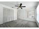 This bedroom features neutral carpet, a ceiling fan, a window and a closet at 22 Bradford Ct, Kissimmee, FL 34758
