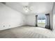 Simple bedroom with carpet, ceiling fan, and window overlooking backyard at 22 Bradford Ct, Kissimmee, FL 34758