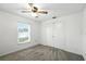 Cozy bedroom features a ceiling fan, a window with blinds and a closet for ample storage at 22 Bradford Ct, Kissimmee, FL 34758