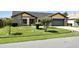 Residential house displaying an attached two-car garage and well-kept front yard and landscaping at 22 Bradford Ct, Kissimmee, FL 34758