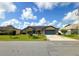 Charming single-Gathering home featuring a two-car garage and manicured front lawn with colorful bushes at 22 Bradford Ct, Kissimmee, FL 34758