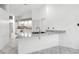 Bright kitchen features a breakfast bar with granite countertops, and all white cabinetry at 22 Bradford Ct, Kissimmee, FL 34758