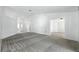 A spacious living room featuring neutral tones, carpet, and multiple entrances and exits at 22 Bradford Ct, Kissimmee, FL 34758