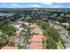 Stunning aerial view of home with red tile roof, screened pool, lush landscaping, and community golf course in the background at 2256 Kettle Dr, Orlando, FL 32835