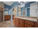 The bathroom has double sinks, granite counters, tile floors and walls, and a glass door leading to the shower at 2256 Kettle Dr, Orlando, FL 32835