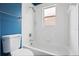 This bright bathroom features a shower and tub combination with white tiling at 2256 Kettle Dr, Orlando, FL 32835