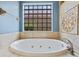 The bathtub features tile surround and a glass block window at 2256 Kettle Dr, Orlando, FL 32835