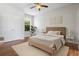 Bright bedroom features a ceiling fan, neutral decor, and wood-look flooring at 2256 Kettle Dr, Orlando, FL 32835