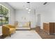 Bedroom featuring a crib and modern furniture with ample natural light at 2256 Kettle Dr, Orlando, FL 32835