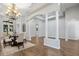 Bright dining room features columns, wood floors, and chandelier at 2256 Kettle Dr, Orlando, FL 32835