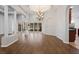 Formal dining area features chandelier, columns and wood floors at 2256 Kettle Dr, Orlando, FL 32835