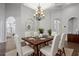 Bright dining room features wood table with white chairs and chandelier at 2256 Kettle Dr, Orlando, FL 32835