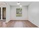 This empty room features tiled flooring, a large window, and modern lighting fixtures at 2256 Kettle Dr, Orlando, FL 32835