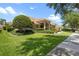 A beautiful single-story house featuring manicured lawns, a tile roof, and decorative shrubbery at 2256 Kettle Dr, Orlando, FL 32835