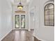 Inviting foyer with decorative front doors and archway features, and decorative lighting at 2256 Kettle Dr, Orlando, FL 32835