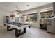 Bright game room with a pool table, tv, outdoor kitchen, and large windows overlooking the pool at 2256 Kettle Dr, Orlando, FL 32835