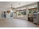 Bright game room with large windows overlooking the pool, outdoor kitchen, and neutral-colored tile flooring at 2256 Kettle Dr, Orlando, FL 32835