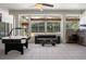 Bright game room featuring an air hockey table, sofa, and outdoor kitchen with stainless steel appliances at 2256 Kettle Dr, Orlando, FL 32835