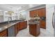 This spacious kitchen features granite countertops, an island, stainless steel appliances, and tile flooring at 2256 Kettle Dr, Orlando, FL 32835