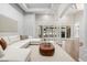 Bright living room with white sectional sofa, brown leather ottoman, and access to the outdoors through glass doors at 2256 Kettle Dr, Orlando, FL 32835