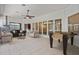 Staged living area with large windows, a foosball table, and a stainless steel kitchen area at 2256 Kettle Dr, Orlando, FL 32835
