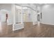 Bright, open-concept living space with hardwood floors, decorative columns, and access to other rooms in the house at 2256 Kettle Dr, Orlando, FL 32835