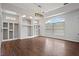 Bright, open living room features a large window, hardwood floors, and built-in shelving at 2256 Kettle Dr, Orlando, FL 32835