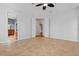 A bright main bedroom features tile flooring, a ceiling fan, and an ensuite bathroom entrance with double doors at 2256 Kettle Dr, Orlando, FL 32835