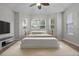 Bright main bedroom features tray ceiling, ceiling fan, neutral paint, and many windows at 2256 Kettle Dr, Orlando, FL 32835