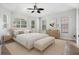 Bright main bedroom features tray ceiling, ceiling fan, neutral paint, and many windows at 2256 Kettle Dr, Orlando, FL 32835