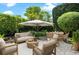 An outdoor seating area with white furniture, surrounded by lush greenery at 2256 Kettle Dr, Orlando, FL 32835