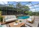 The screened in pool area is a tropical oasis surrounded by lush greenery at 2256 Kettle Dr, Orlando, FL 32835