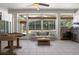 Open sun room featuring tile flooring, foosball table, stainless appliances and views of the backyard pool at 2256 Kettle Dr, Orlando, FL 32835