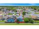 Aerial view showing the layout of the neighborhood with a lake, mature trees, and well-kept lawns at 235 Hidden Springs Cir, Kissimmee, FL 34743