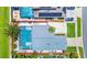 A bird's-eye view shows the home's pool area, grey roof, and proximity to the road at 235 Hidden Springs Cir, Kissimmee, FL 34743