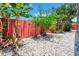 Lush backyard featuring a tropical landscape with various plants and crushed rock at 235 Hidden Springs Cir, Kissimmee, FL 34743