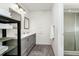 Modern bathroom featuring a gray vanity, ample lighting, and a walk-in shower at 235 Hidden Springs Cir, Kissimmee, FL 34743