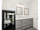 Modern bathroom featuring a double sink vanity, shelving, and ample lighting at 235 Hidden Springs Cir, Kissimmee, FL 34743