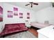 Cozy bedroom offers a sofa, white chair, bed, and modern decor for a comfortable retreat at 235 Hidden Springs Cir, Kissimmee, FL 34743