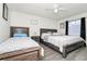 Spacious bedroom featuring two beds, neutral walls, and a ceiling fan for added comfort at 235 Hidden Springs Cir, Kissimmee, FL 34743