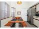 Cozy dining area featuring a built-in bench, wooden table, stainless steel fridge, and neutral decor at 235 Hidden Springs Cir, Kissimmee, FL 34743