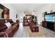 Spacious living room features new flooring, comfortable seating, and decor, great for entertaining guests and relaxing at 235 Hidden Springs Cir, Kissimmee, FL 34743