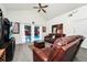 Beautiful living room with leather seating, TV, and sliding glass doors leading to a screened in pool at 235 Hidden Springs Cir, Kissimmee, FL 34743