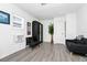 Bright living room featuring a black accent chair, dark sofa, and minimalistic decor at 235 Hidden Springs Cir, Kissimmee, FL 34743