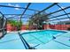 Refreshing screened-in pool surrounded by lush greenery and a privacy fence at 235 Hidden Springs Cir, Kissimmee, FL 34743